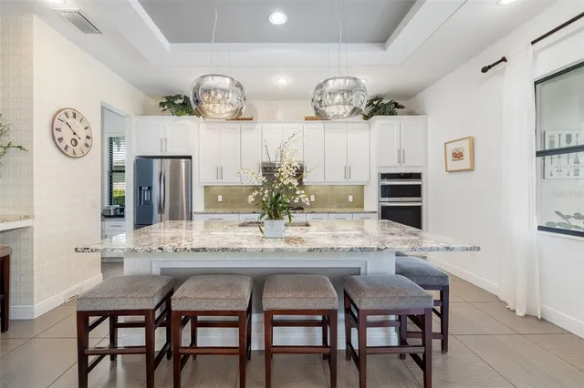 a kitchen with a refrigerator and a sink