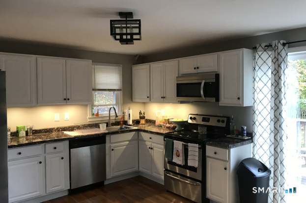 224 Anns Farm Road Hamden, CT 06518 - Photo 2 of 17 a kitchen with granite countertop a sink a stove and cabinets