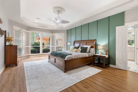 a bedroom with a large bed and a large window