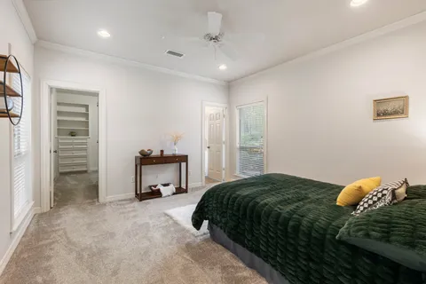 a bedroom with a bed and a view of kitchen