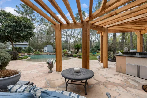 a backyard of a house with fountain table and chairs