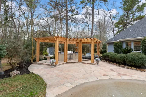 a view of a building with sitting area and garden