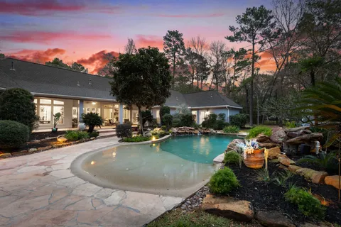 a view of a swimming pool with lounge chairs in patio