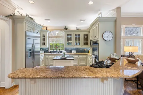 a dining room with furniture a chandelier and wooden floor
