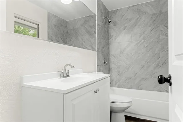 a bathroom with a sink a toilet and a tub