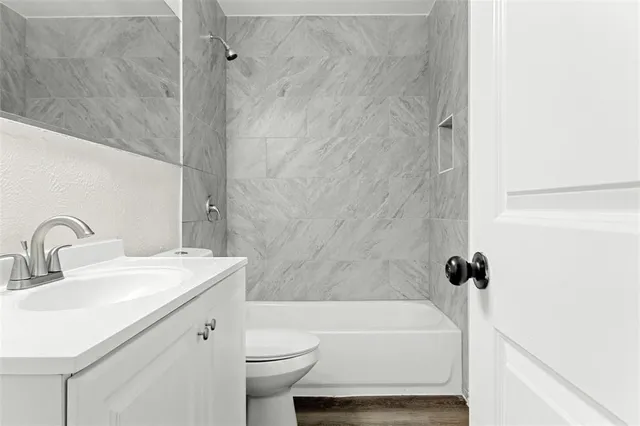 a bathroom with a sink toilet and shower