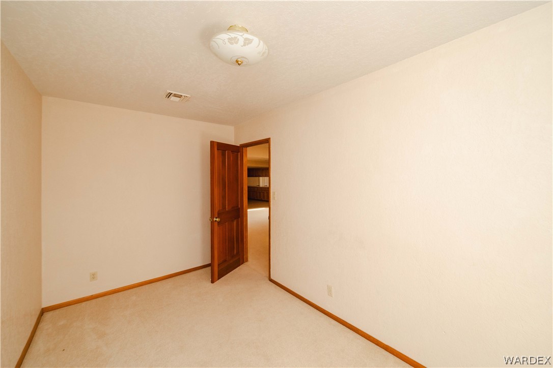 2100 East Valley View Road Kingman, AZ 86409 - Photo 28 of 53 Neutral-toned walls complement plush carpeting