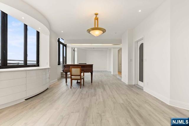 100 Carlyle Drive, Unit PHDN Cliffside Park, NJ 07010 - Photo 12 of 39 a view of a room with furniture and wooden floor