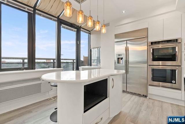 100 Carlyle Drive, Unit PHDN Cliffside Park, NJ 07010 - Photo 15 of 39 a kitchen with a sink stainless steel appliances and cabinets