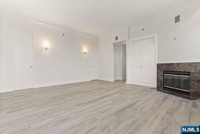 100 Carlyle Drive, Unit PHDN Cliffside Park, NJ 07010 - Photo 25 of 39 a view of an empty room with wooden floor fireplace and a window