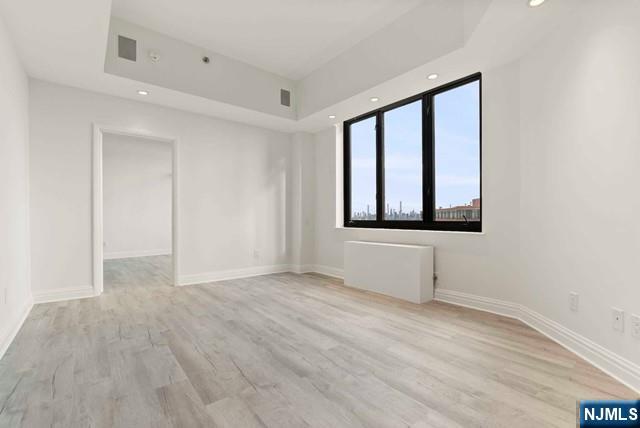 100 Carlyle Drive, Unit PHDN Cliffside Park, NJ 07010 - Photo 32 of 39 a view of an empty room with a window and wooden floor