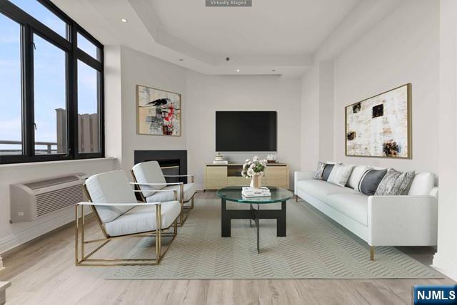 100 Carlyle Drive, Unit PHDN Cliffside Park, NJ 07010 - Photo 5 of 39 a living room with furniture a flat screen tv and a large window