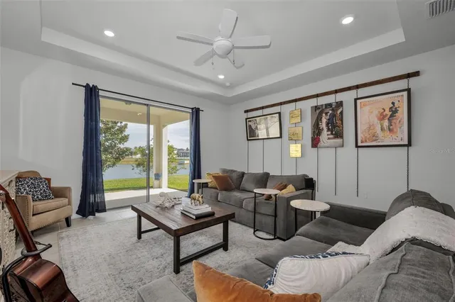 a kitchen with stainless steel appliances granite countertop a sink a stove a refrigerator and island with wooden floor