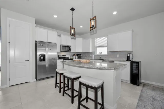 a bedroom with a bed and a lamp on the dresser