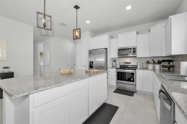 a bedroom with a bed and a lamp