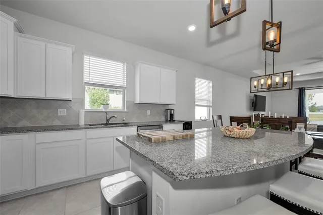 a bathroom with a granite countertop sink toilet a mirror a shower and a mirror
