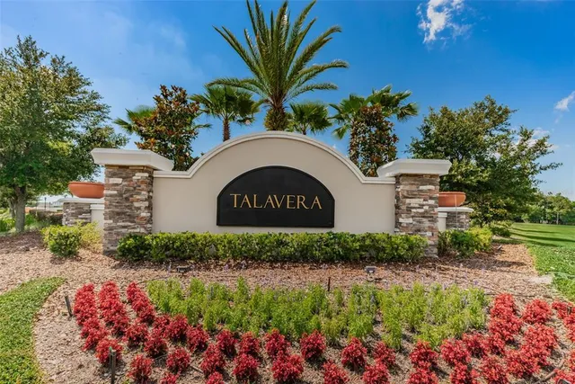 a front view of house with yard and trees around