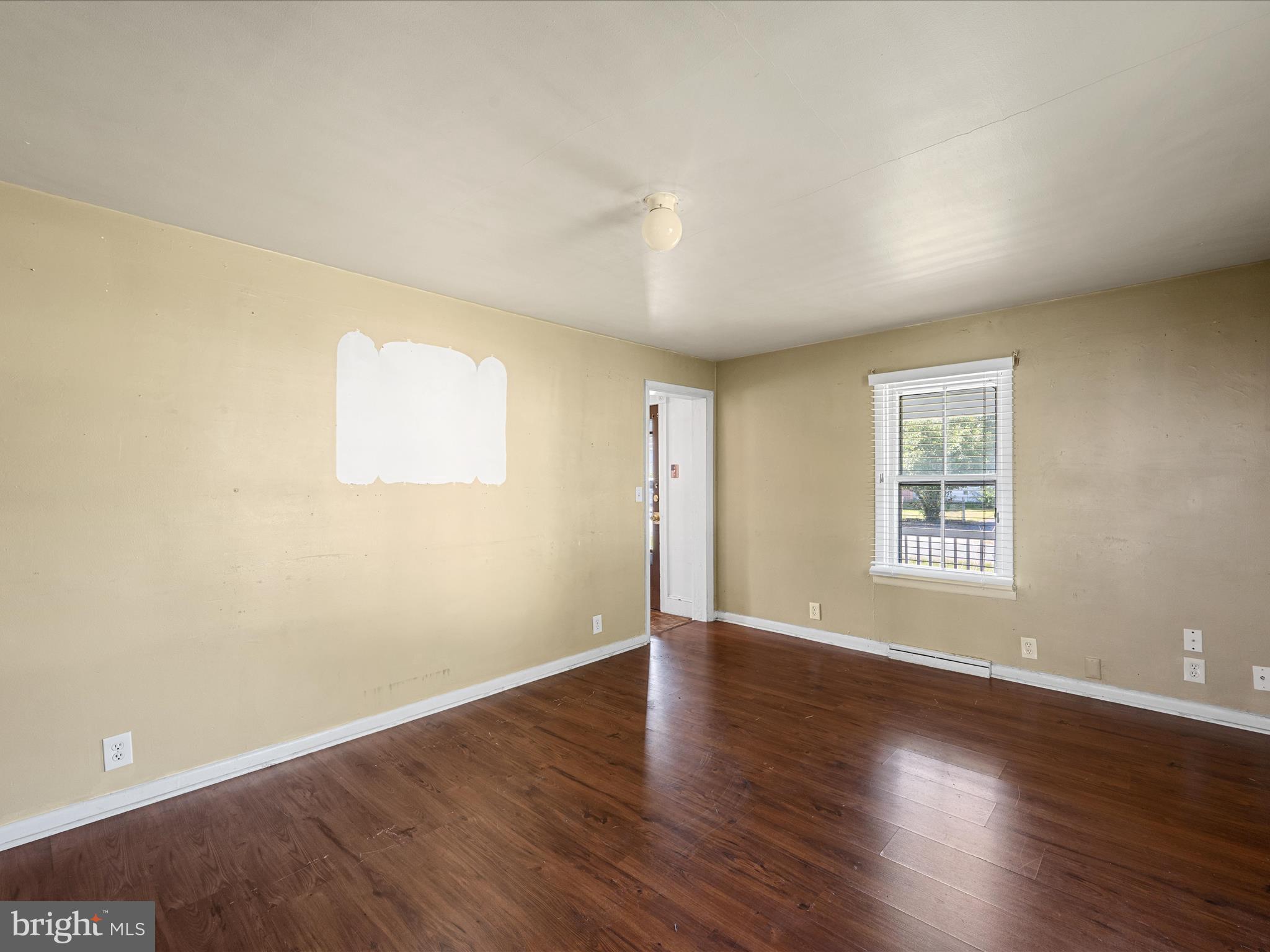 306 West 6th Avenue Ranson, WV 25438 - Photo 14 of 46 an empty room with wooden floor and windows