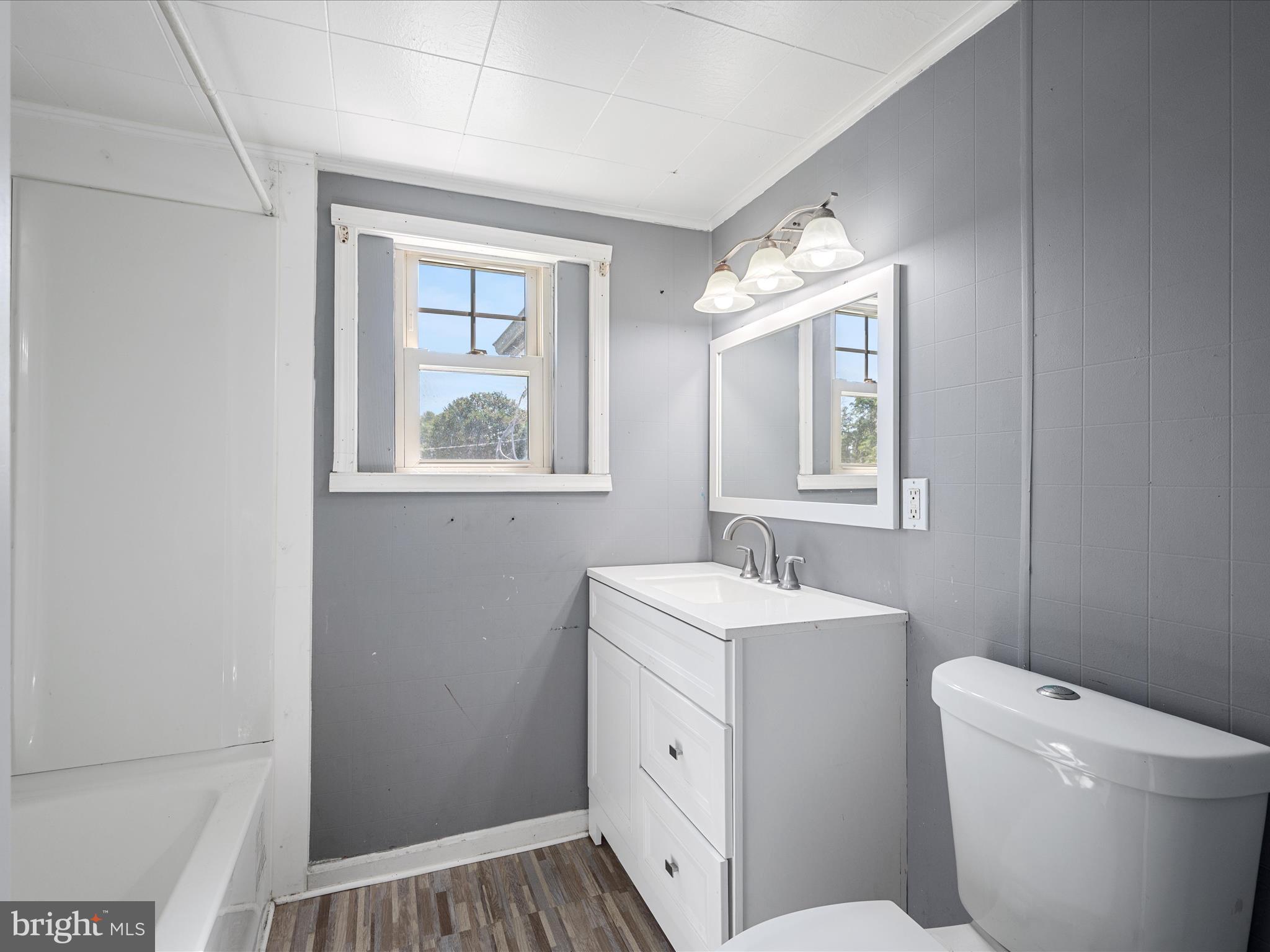 306 West 6th Avenue Ranson, WV 25438 - Photo 23 of 46 a bathroom with a sink toilet vanity and window