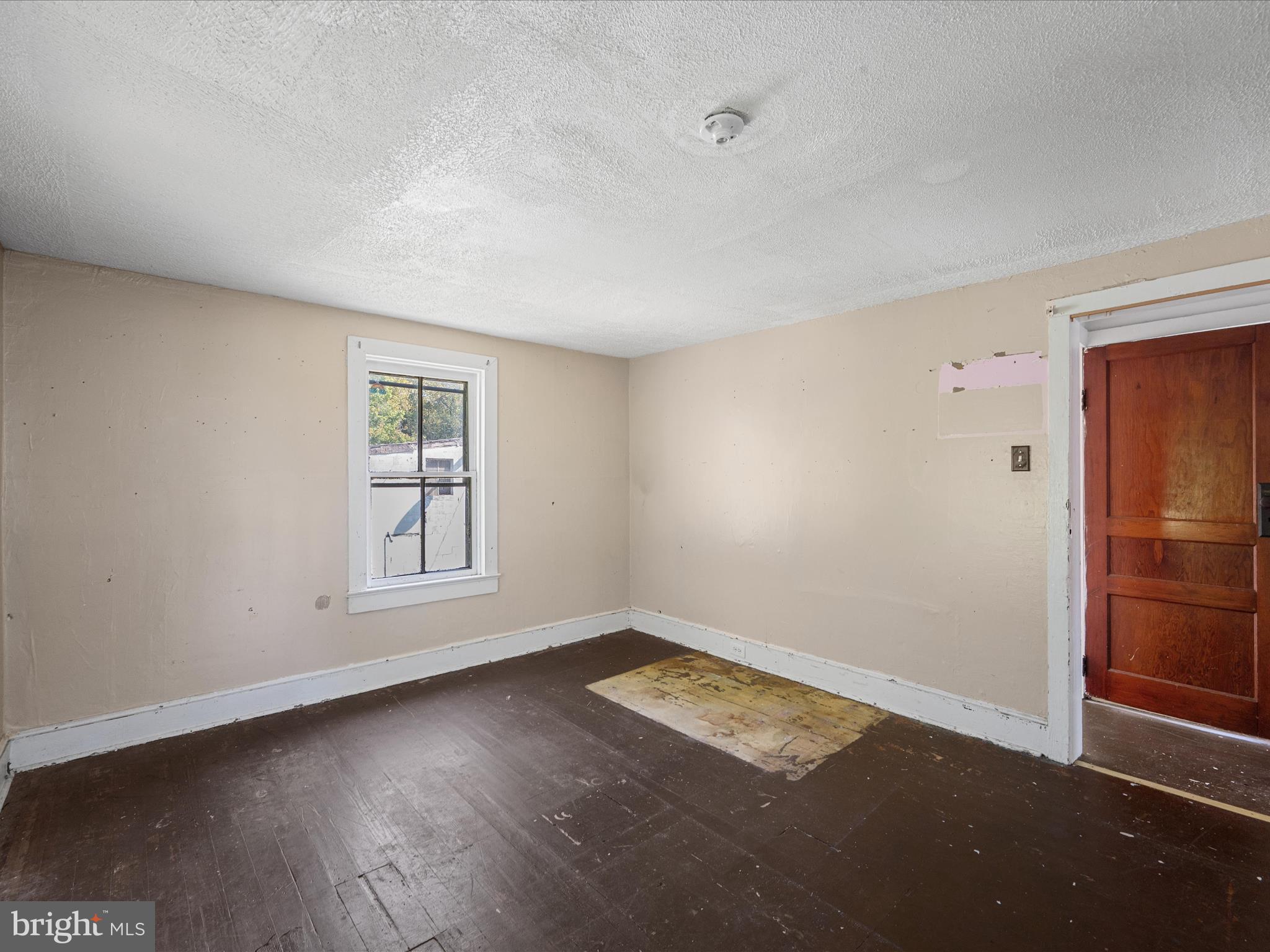 306 West 6th Avenue Ranson, WV 25438 - Photo 26 of 46 an empty room with wooden floor and windows