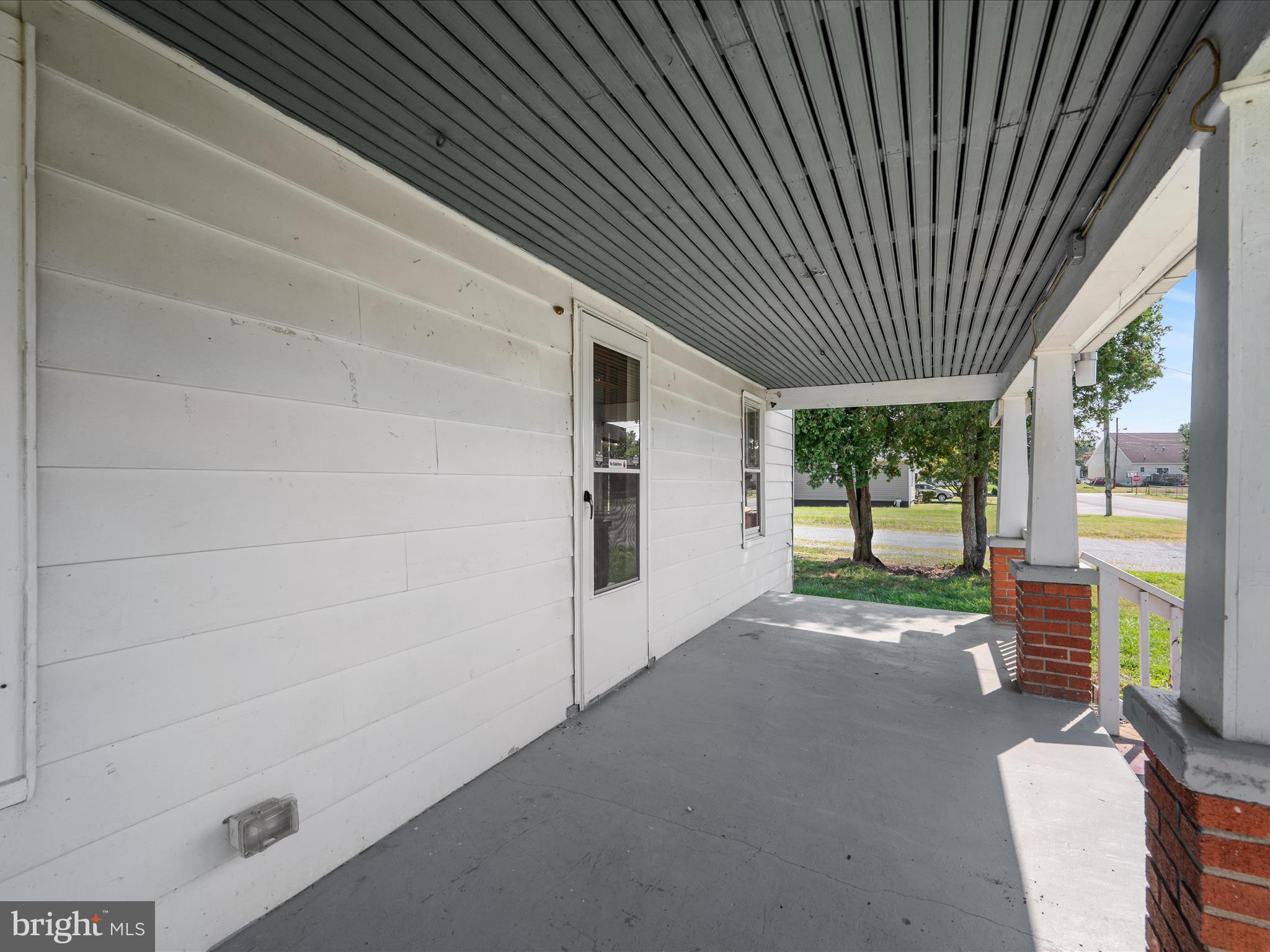 306 West 6th Avenue Ranson, WV 25438 - Photo 8 of 46 a view of a porch with furniture and floor to ceiling window