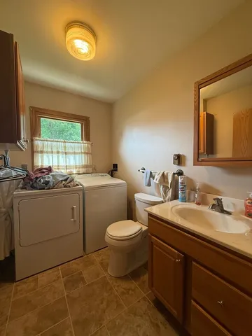 a bathroom with a toilet sink and mirror