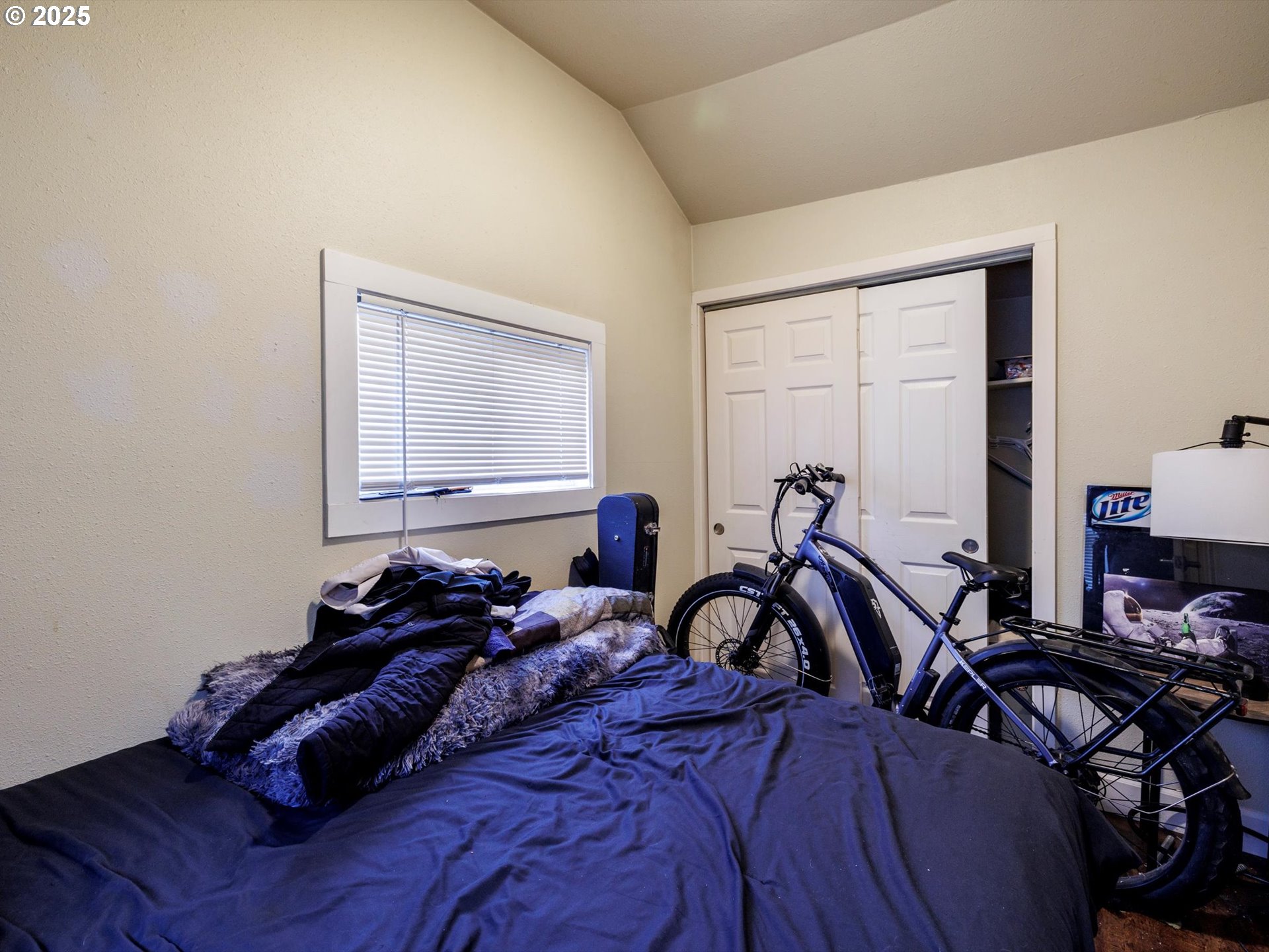 4840 Northeast 99th Avenue Portland, OR 97220 - Photo 5 of 15 a bed sitting in a bedroom next to a window