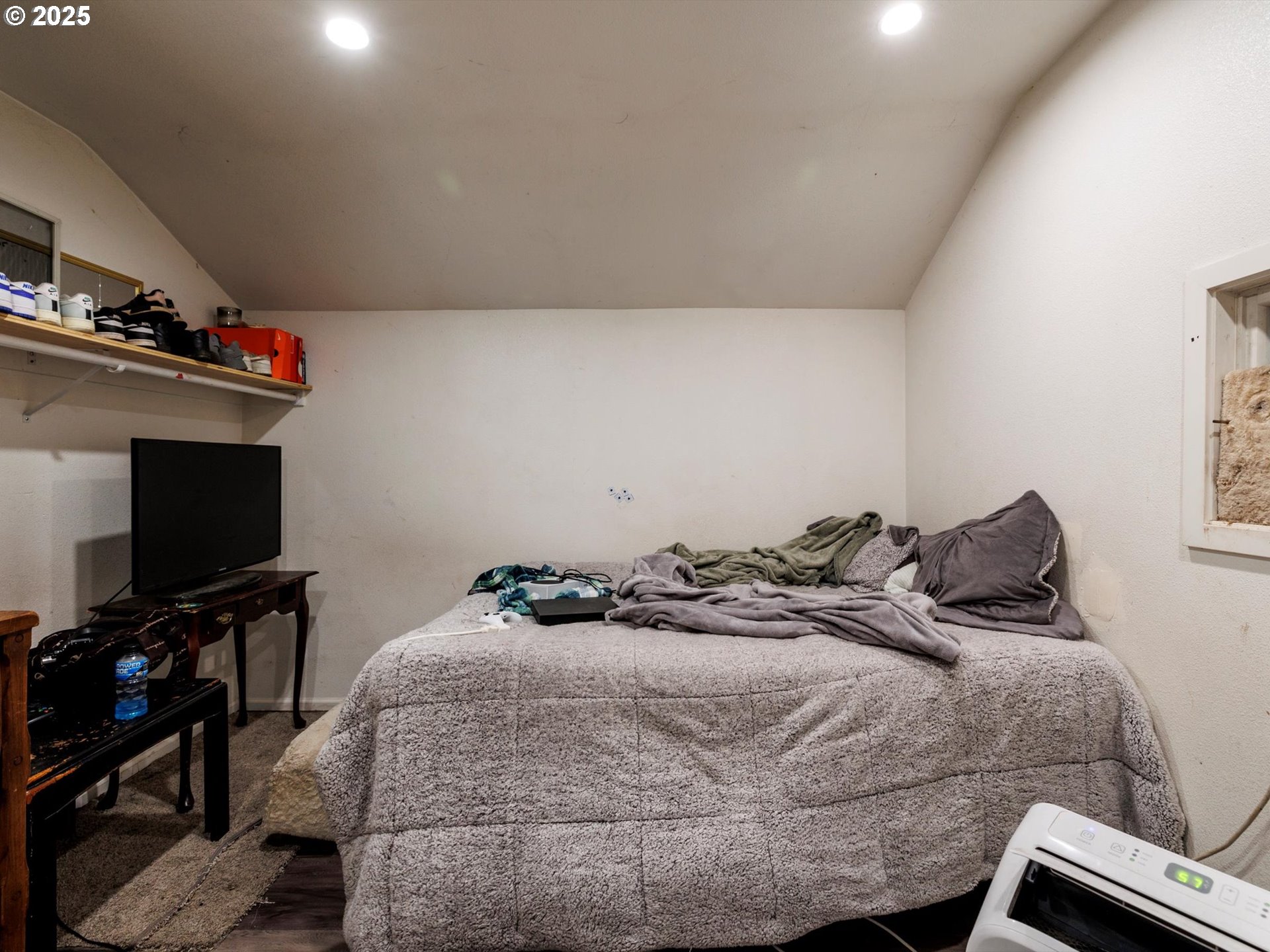 4840 Northeast 99th Avenue Portland, OR 97220 - Photo 7 of 15 a bedroom with a bed and a flat screen tv