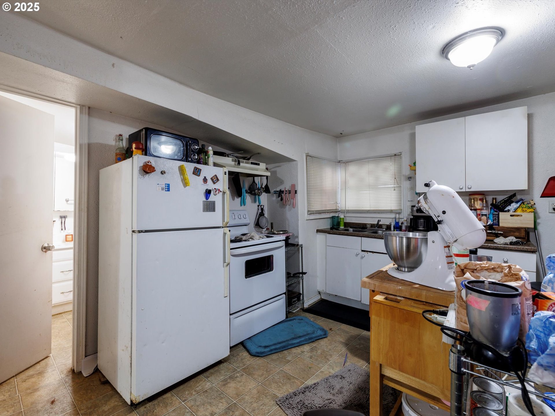 4840 Northeast 99th Avenue Portland, OR 97220 - Photo 10 of 15 a kitchen with a refrigerator a stove a sink and a chairs