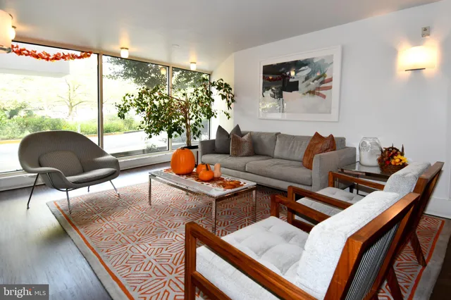 a lobby with furniture and chandelier