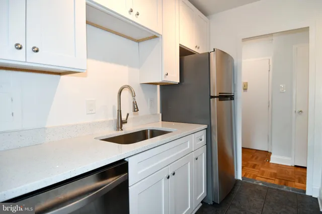 a kitchen with stainless steel appliances granite countertop a refrigerator and a sink