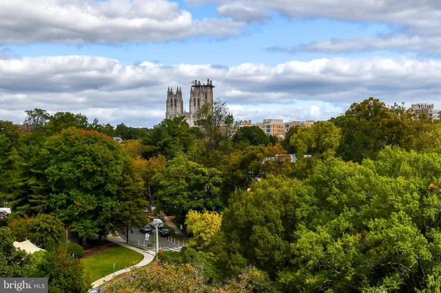 a street sign that is sitting on a brick wall