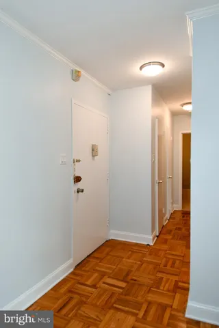 a view of a room with wooden floor