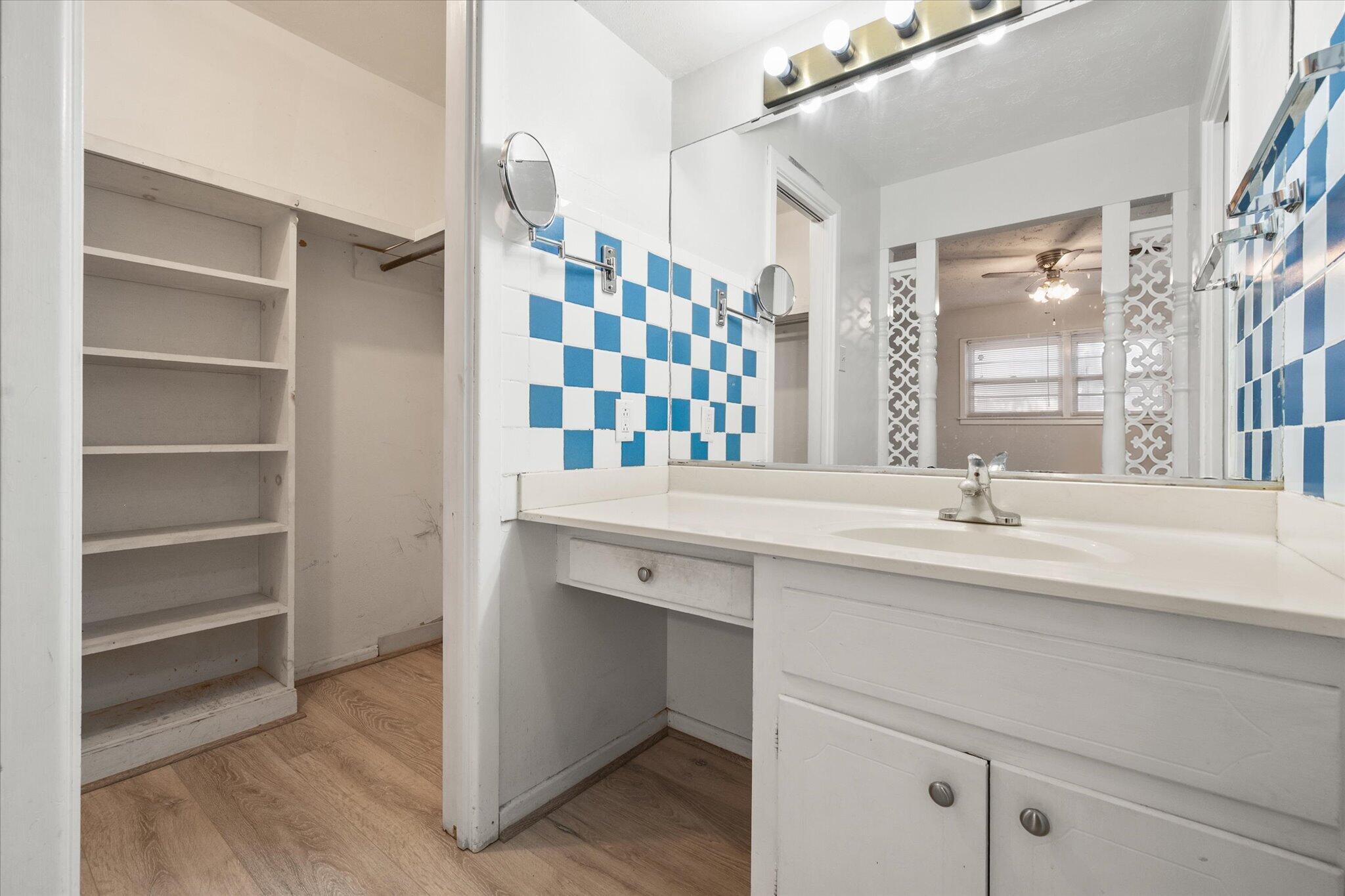 4604 27th Street Lubbock, TX 79410 - Photo 16 of 36 a bathroom with a sink and a mirror