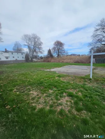 a view of yard with ocean and mountain view in back