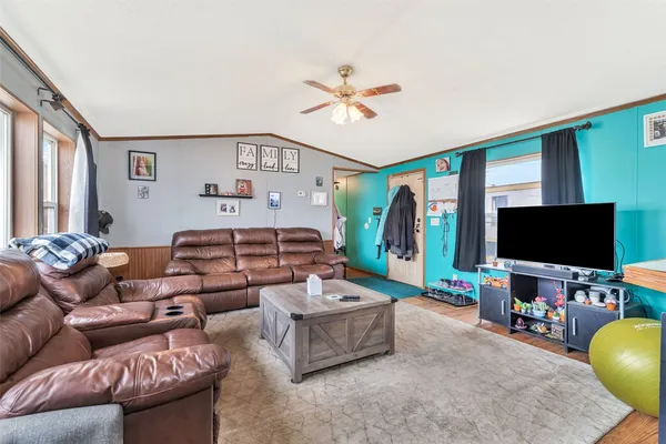 a living room with furniture and a flat screen tv