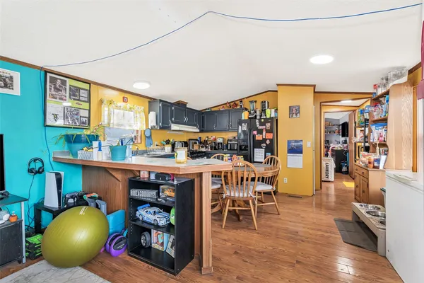 a kitchen with stainless steel appliances dining table and chairs