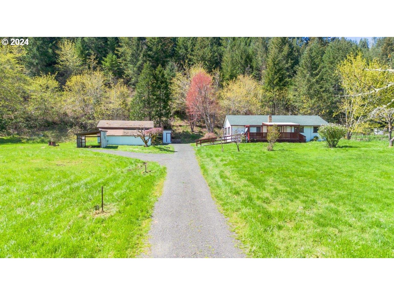 6151 Willis Creek Road Winston, OR 97496 - Photo 1 of 46 a open area with trees in the background
