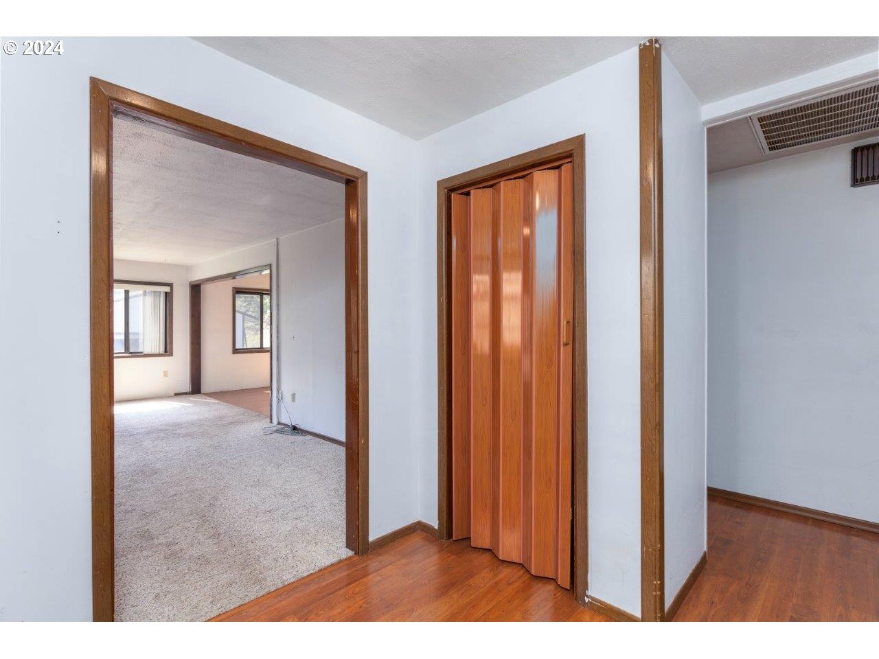6151 Willis Creek Road Winston, OR 97496 - Photo 5 of 46 a view hallway with wooden floor