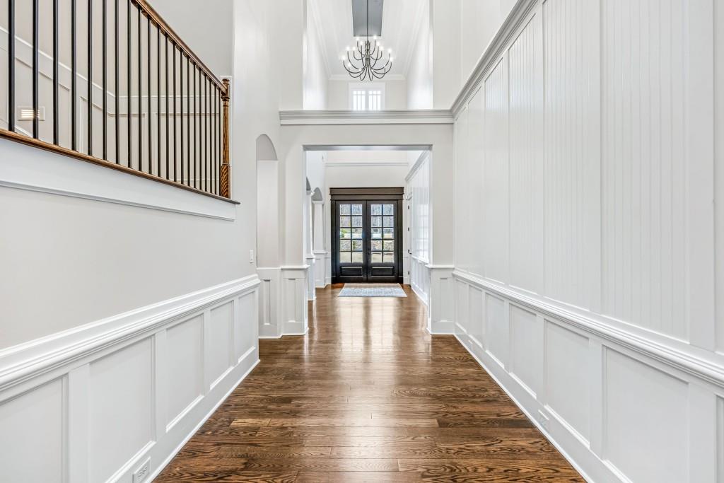 47 Fern Leaf Way Newnan, GA 30265 - Photo 14 of 65 a view of a hallway with wooden floor and staircase