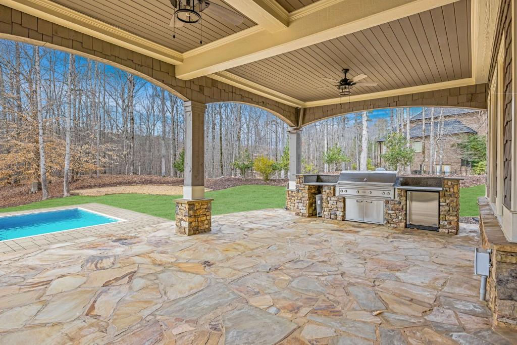 47 Fern Leaf Way Newnan, GA 30265 - Photo 62 of 65 a view of a patio with a table and chairs under an umbrella