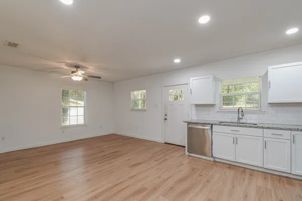 a view of kitchen with furniture and wooden floor