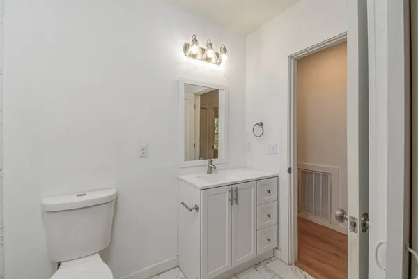 a bathroom with a toilet sink and mirror