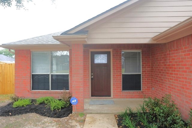 16210 Rosenridge Drive Houston, TX 77053 - Photo 8 of 12 a front view of a house with a yard and garage