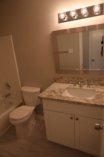 16210 Rosenridge Drive Houston, TX 77053 - Photo 10 of 13 a bathroom with a granite countertop toilet and sink