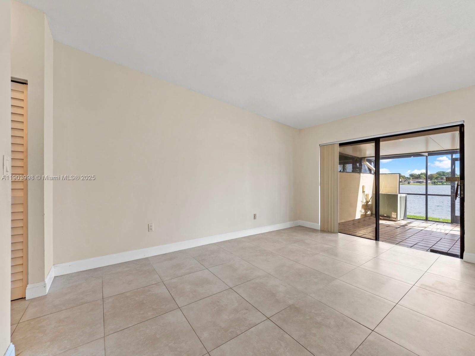 19233 Northwest 64th Court Hialeah, FL 33015 - Photo 13 of 34 an empty room with sliding glass door and shower