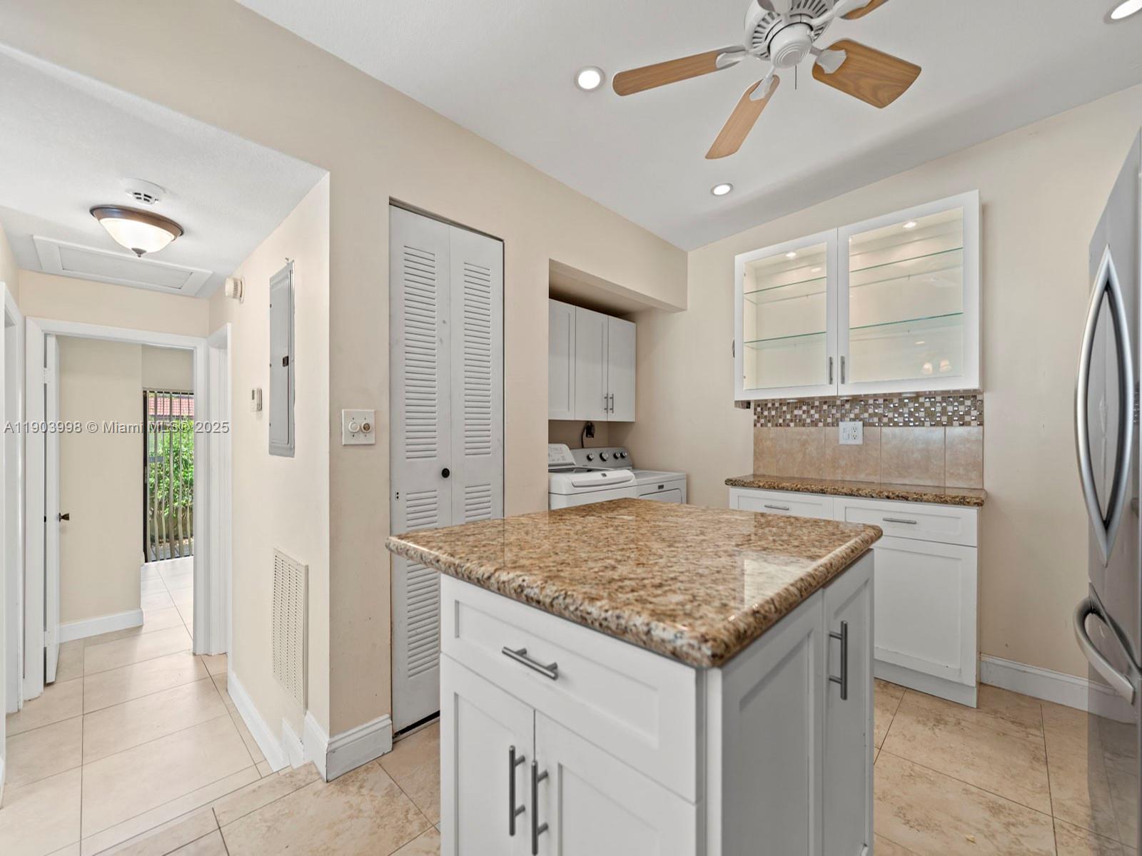 19233 Northwest 64th Court Hialeah, FL 33015 - Photo 20 of 34 a bathroom with a granite countertop sink and a mirror