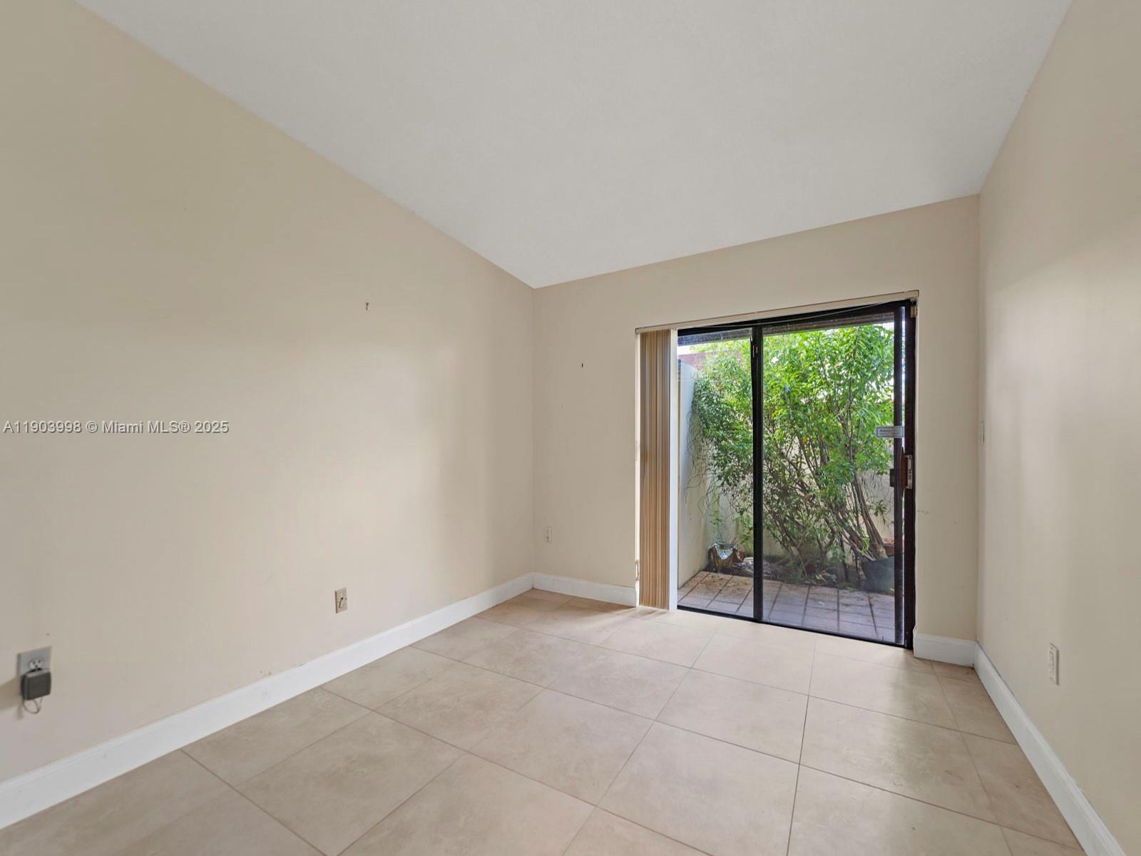 19233 Northwest 64th Court Hialeah, FL 33015 - Photo 23 of 34 a view of an empty room with wooden floor and a window
