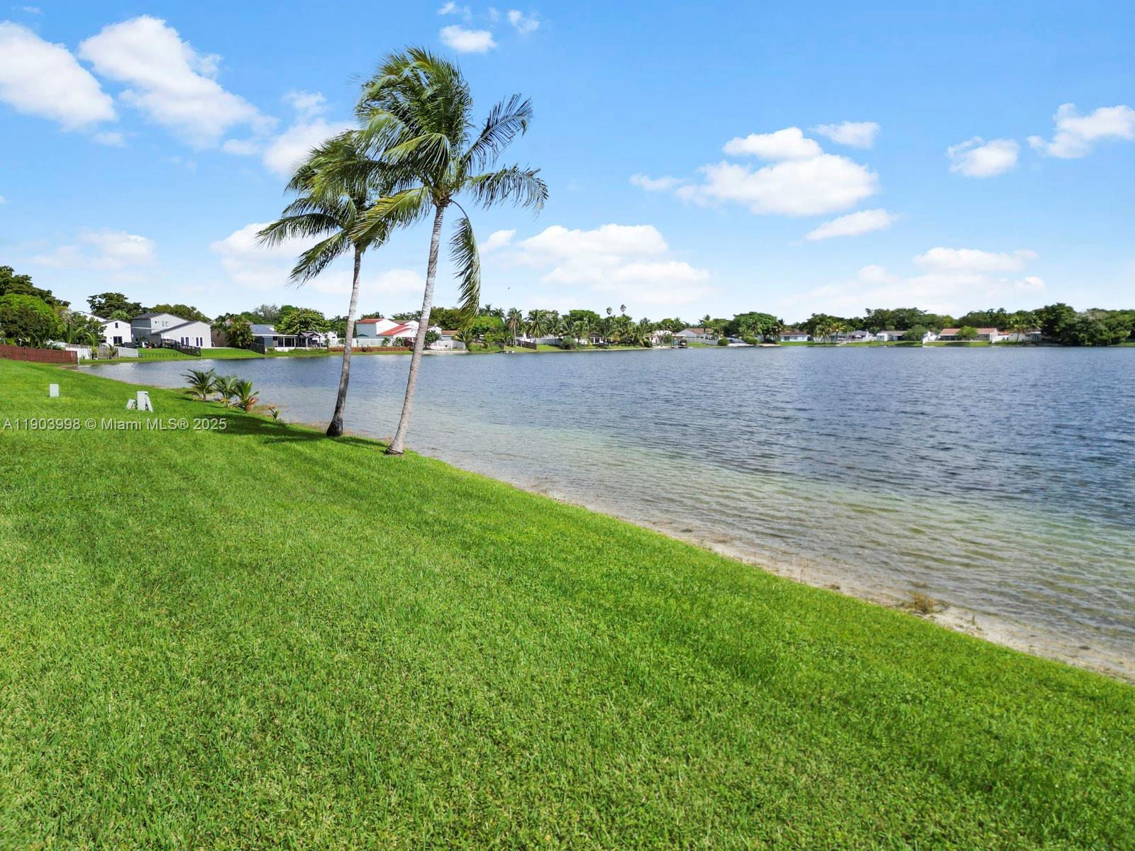 19233 Northwest 64th Court Hialeah, FL 33015 - Photo 4 of 34 a view of a lake with a big yard