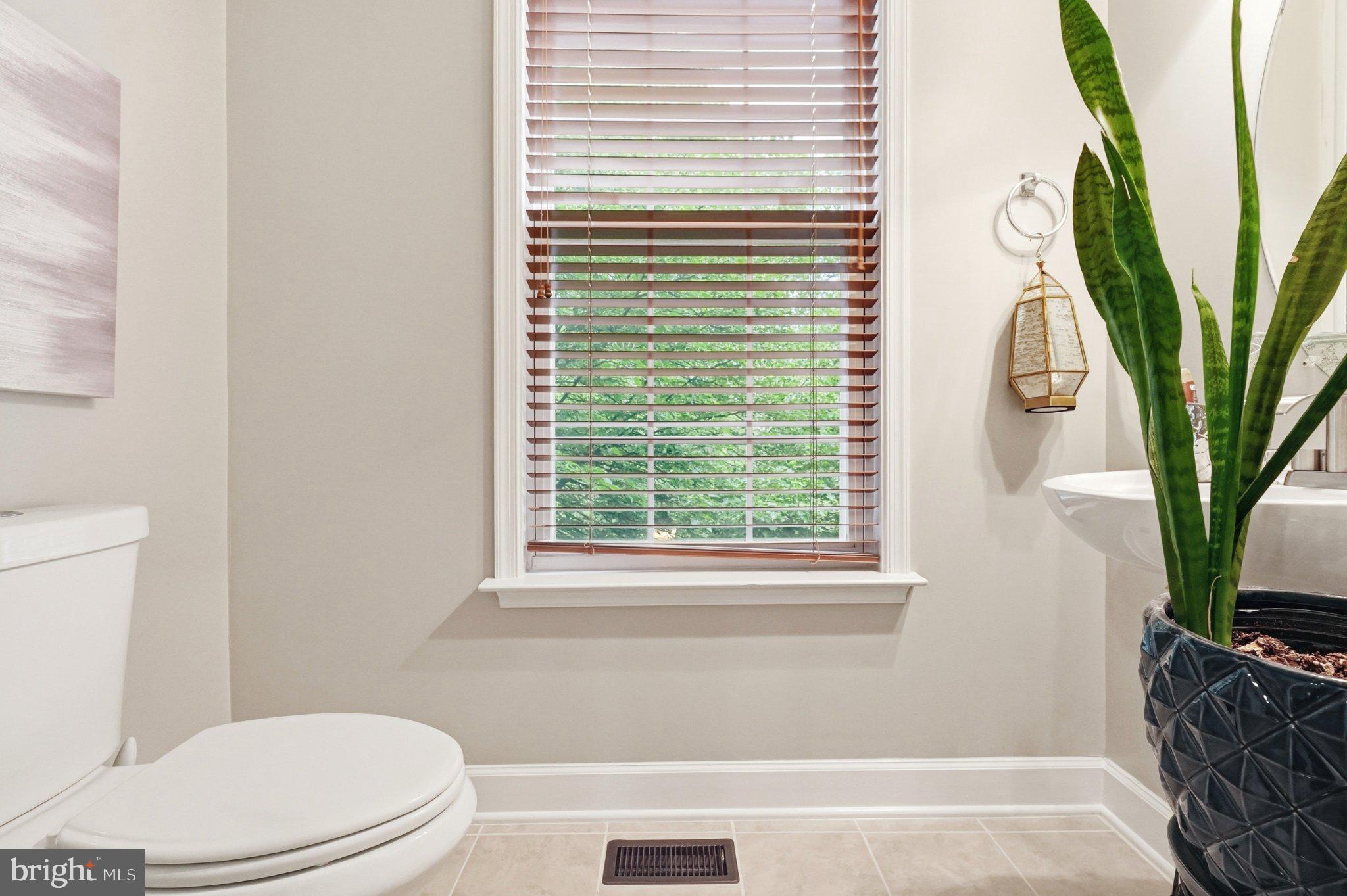 772 Raven Avenue Gaithersburg, MD 20877 - Photo 13 of 30 a white toilet sitting next to a window